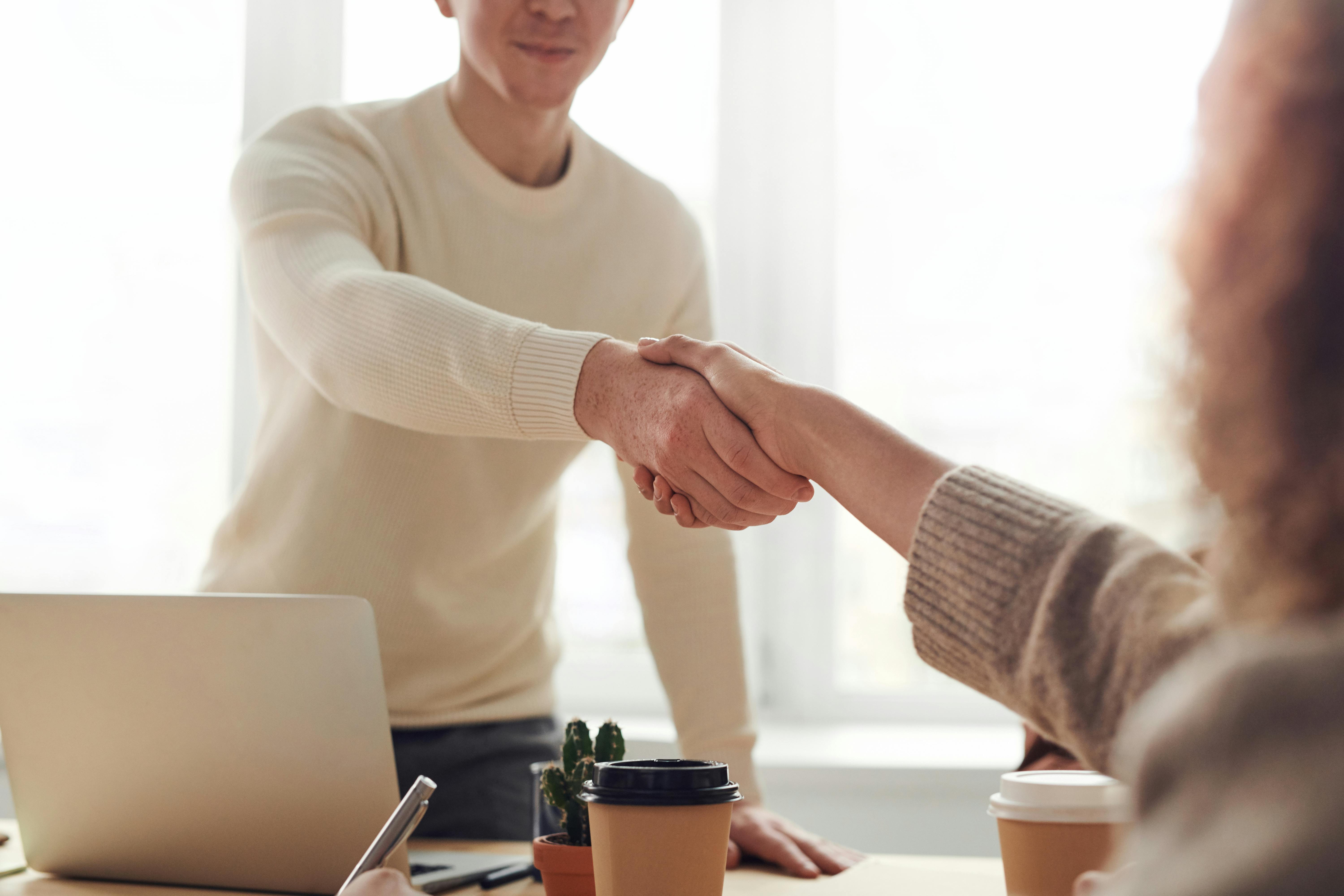 candidate and interviewer shaking hands at a job interview